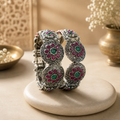 Oxidised ruby green floral disc adjustable folding kada - front view