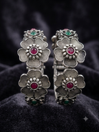 Oxidised silver floral ruby stone folding kada worn on wrist