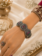 Oxidised peacock floral ruby green stone folding kada worn on wrist